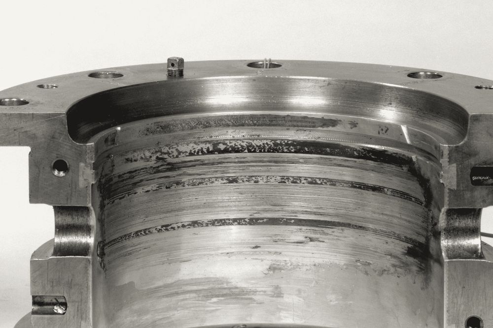 A large bronze bearing shell with wear marks in its bore