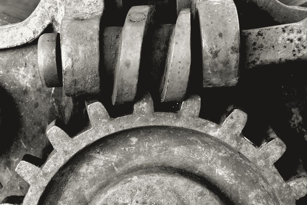A worm gear meshing with its worm inside an old machine